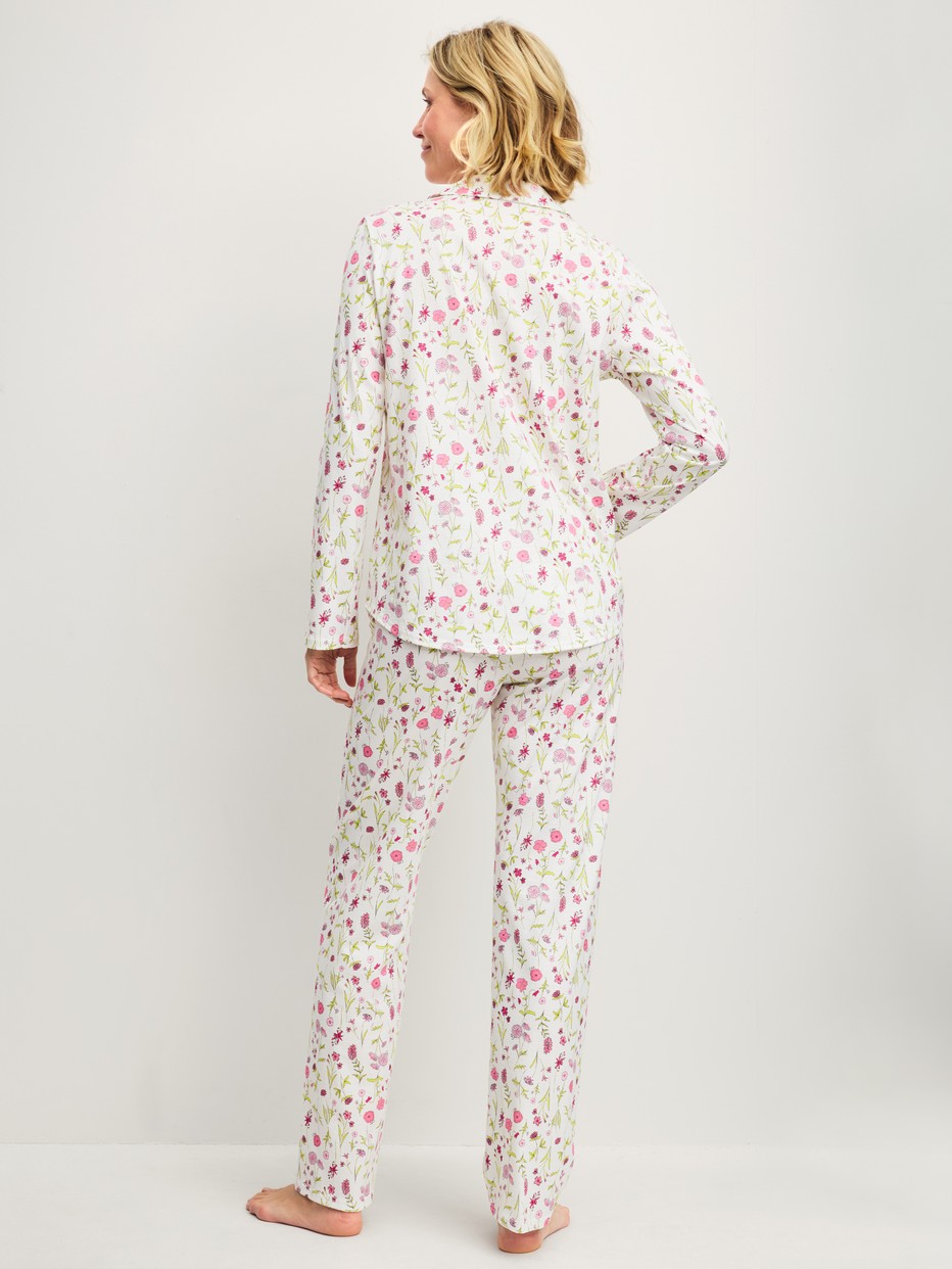 Women model is wearing Button-Up Pyjama made of 100% Cotton in Pink, Floral from the Cotton Special series by CALIDA, Back view