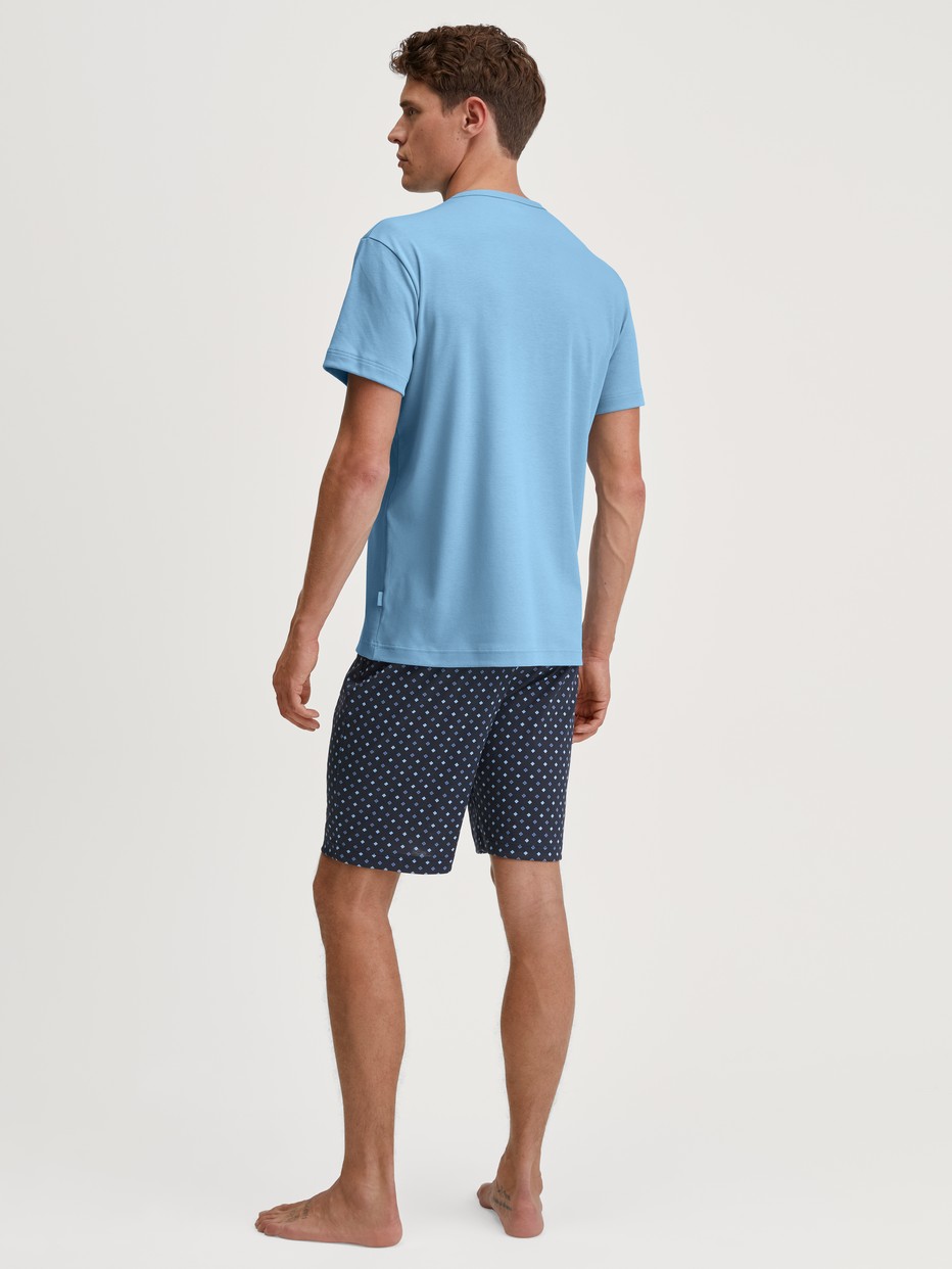 Men model is wearing Short pyjama made of 100% Cotton in Blue, Patterned from the Relax Streamline series by CALIDA, Back view