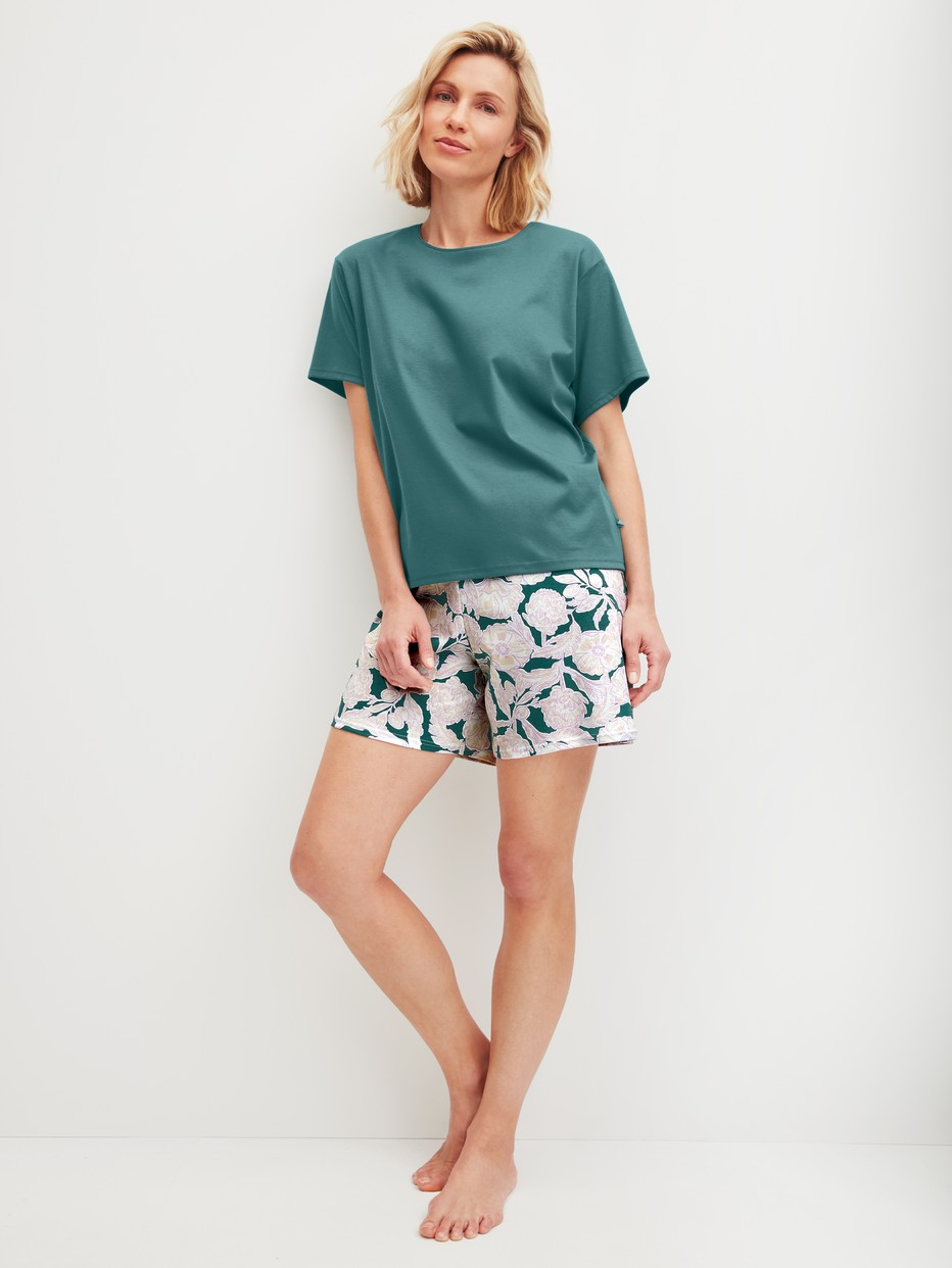 Women model is wearing Short pyjama made of 100% Cotton in Turquoise, Floral from the Botanic Dreams series by CALIDA, Front view