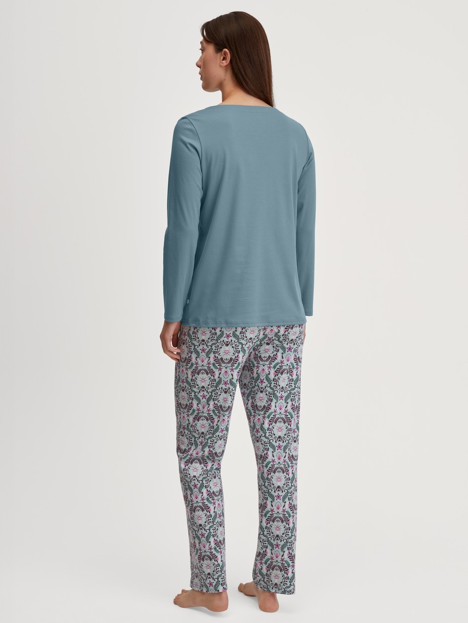 Women model is wearing Pyjamas, long made of 100% Cotton in Blue, Patterned from the Autumn Dreams series by CALIDA, Back view