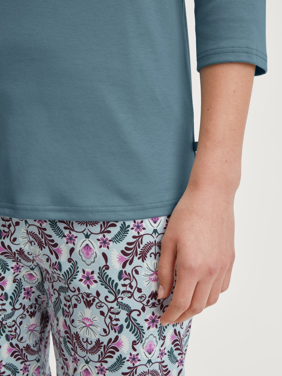 Women model is wearing Capri Pyjama made of 100% Cotton in Blue, Patterned from the Autumn Dreams series by CALIDA, Detail