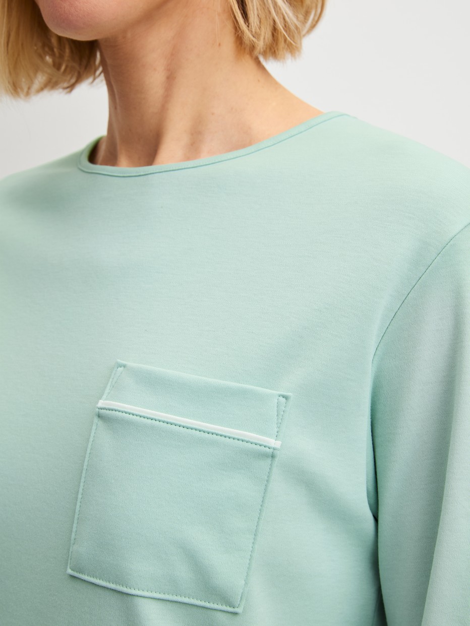 Women model is wearing Pyjama with cuff made of 100% Cotton in Turquoise, Patterned from the Sweet Dreams series by CALIDA, Detail