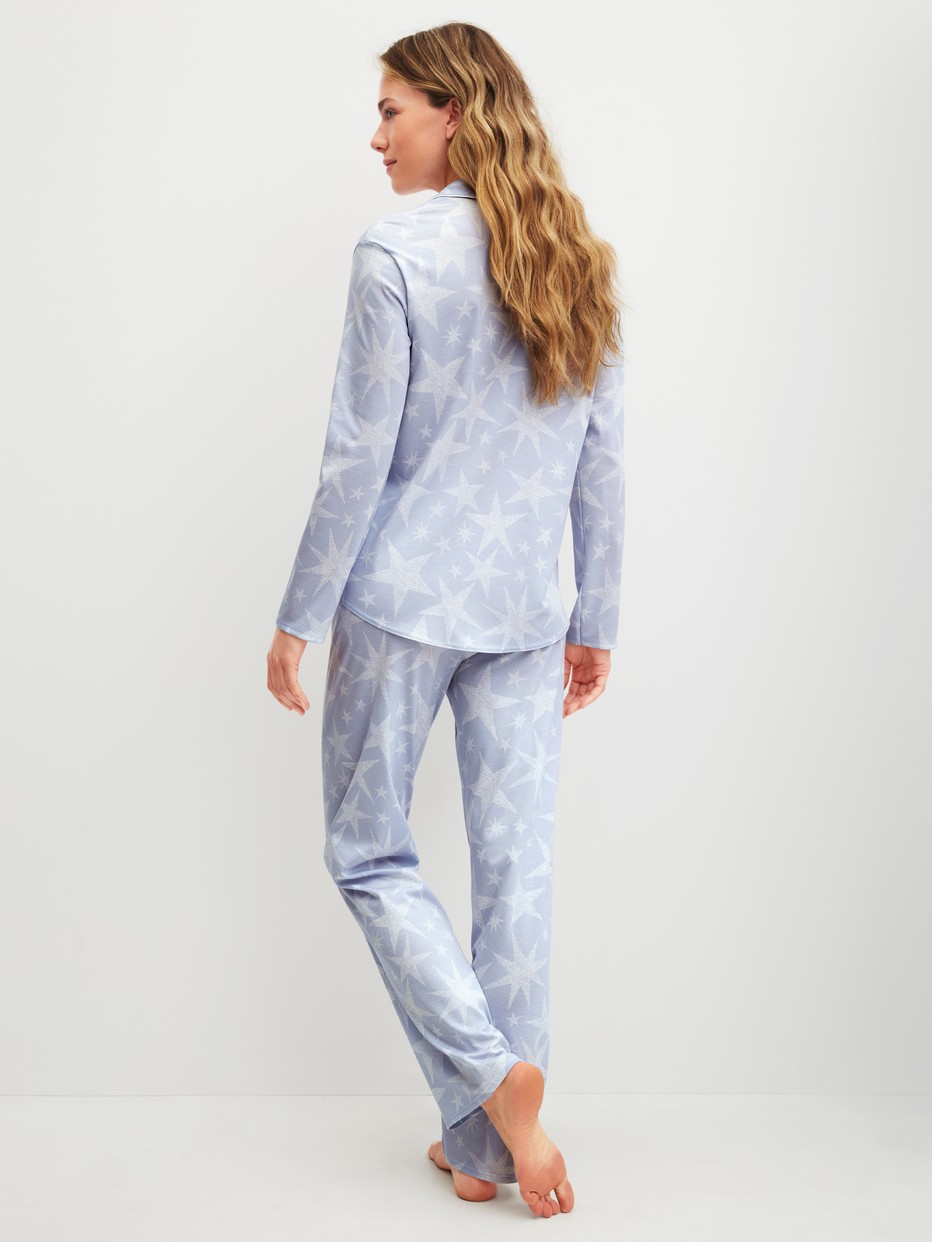 Women model is wearing Button-Up Pyjama made of 100% Cotton in Blue, Patterned from the Cosy Nights series by CALIDA, Back view