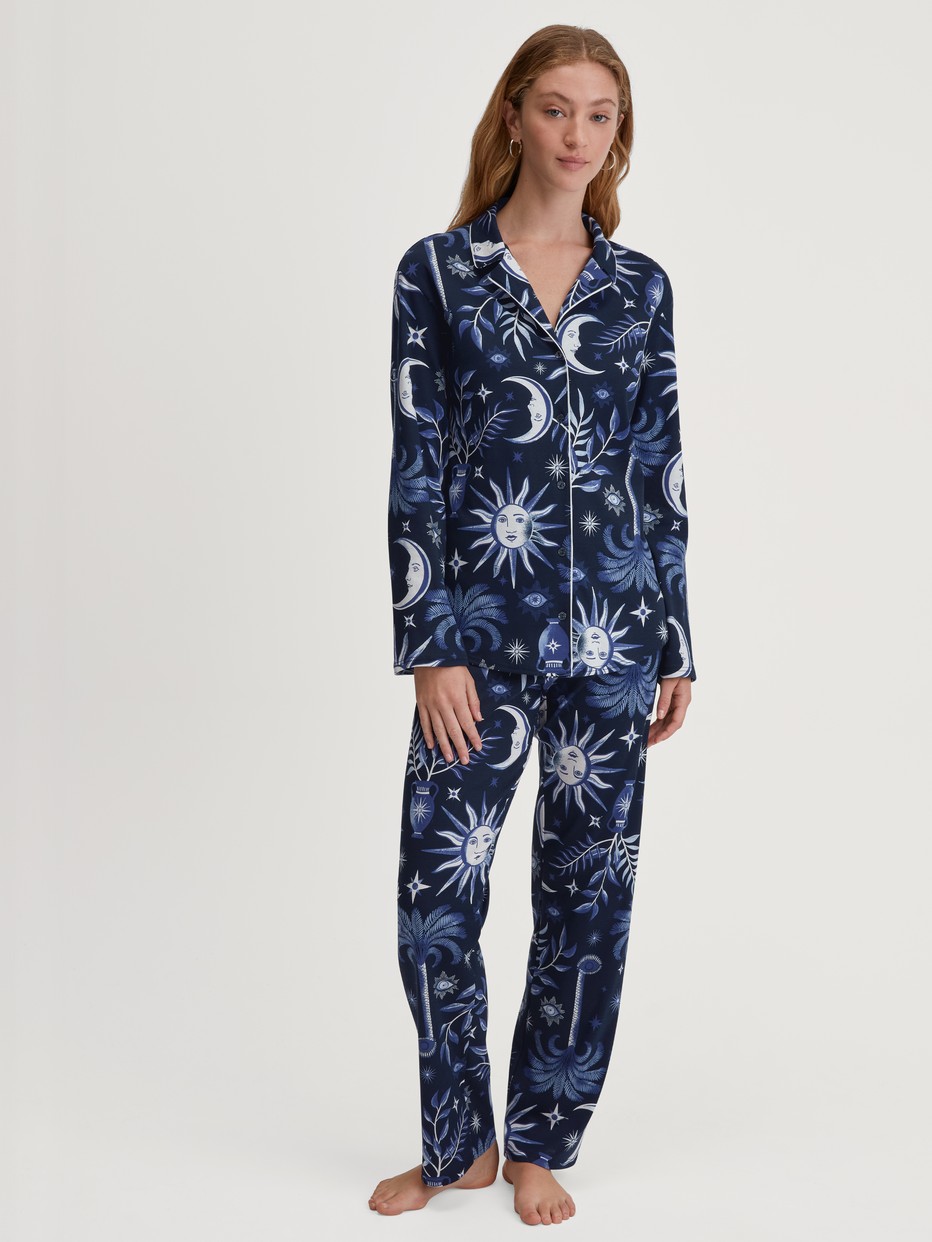 Women model is wearing Button-Up Pyjama made of 100% Cotton in Blue, Patterned from the Winter Dreams series by CALIDA, Front view