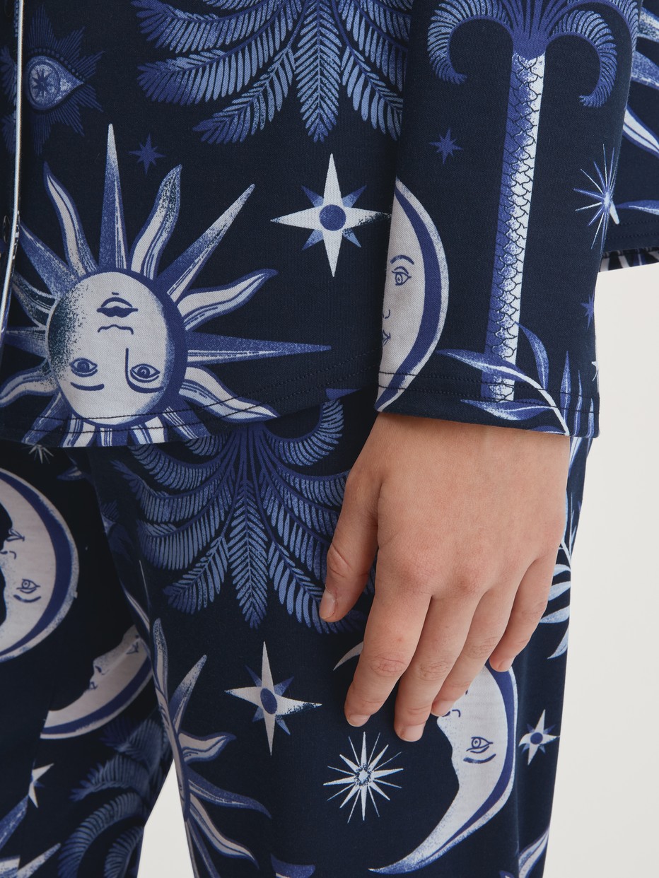 Women model is wearing Button-Up Pyjama made of 100% Cotton in Blue, Patterned from the Winter Dreams series by CALIDA, Detail
