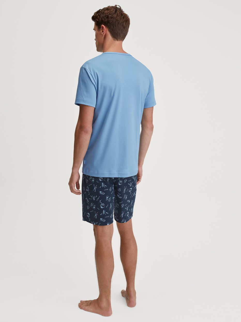 Men model is wearing Short pyjamas made of 100% Cotton in Blue, Patterned from the Relax Swiss Resort series by CALIDA, Back view