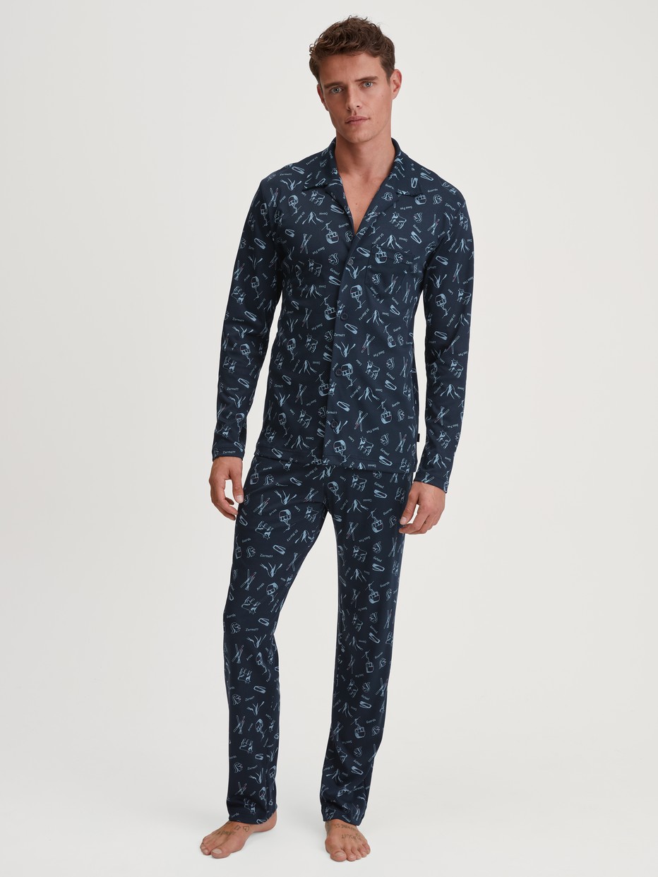 Men model is wearing Button-Up Pyjama made of 100% Cotton in Blue, Patterned from the Relax Swiss Resort series by CALIDA, Front view