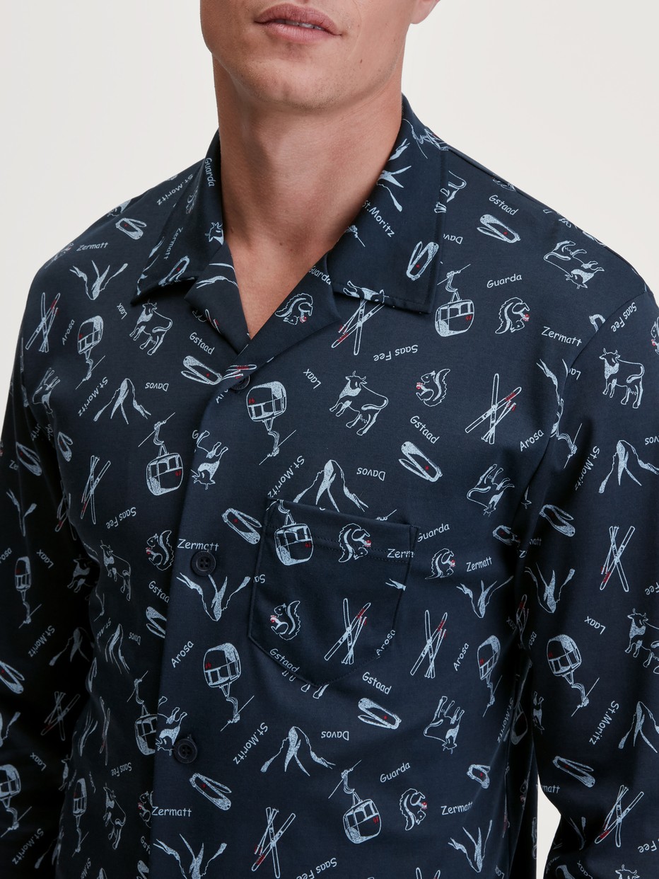 Men model is wearing Button-Up Pyjama made of 100% Cotton in Blue, Patterned from the Relax Swiss Resort series by CALIDA, Detail