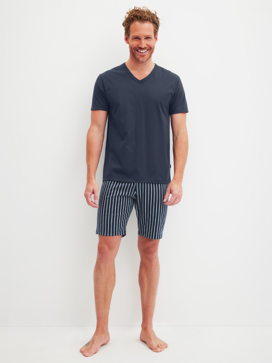Men model is wearing Short pyjama made of 100% Cotton in Blue, Patterned from the Cotton Special series by CALIDA, Front view