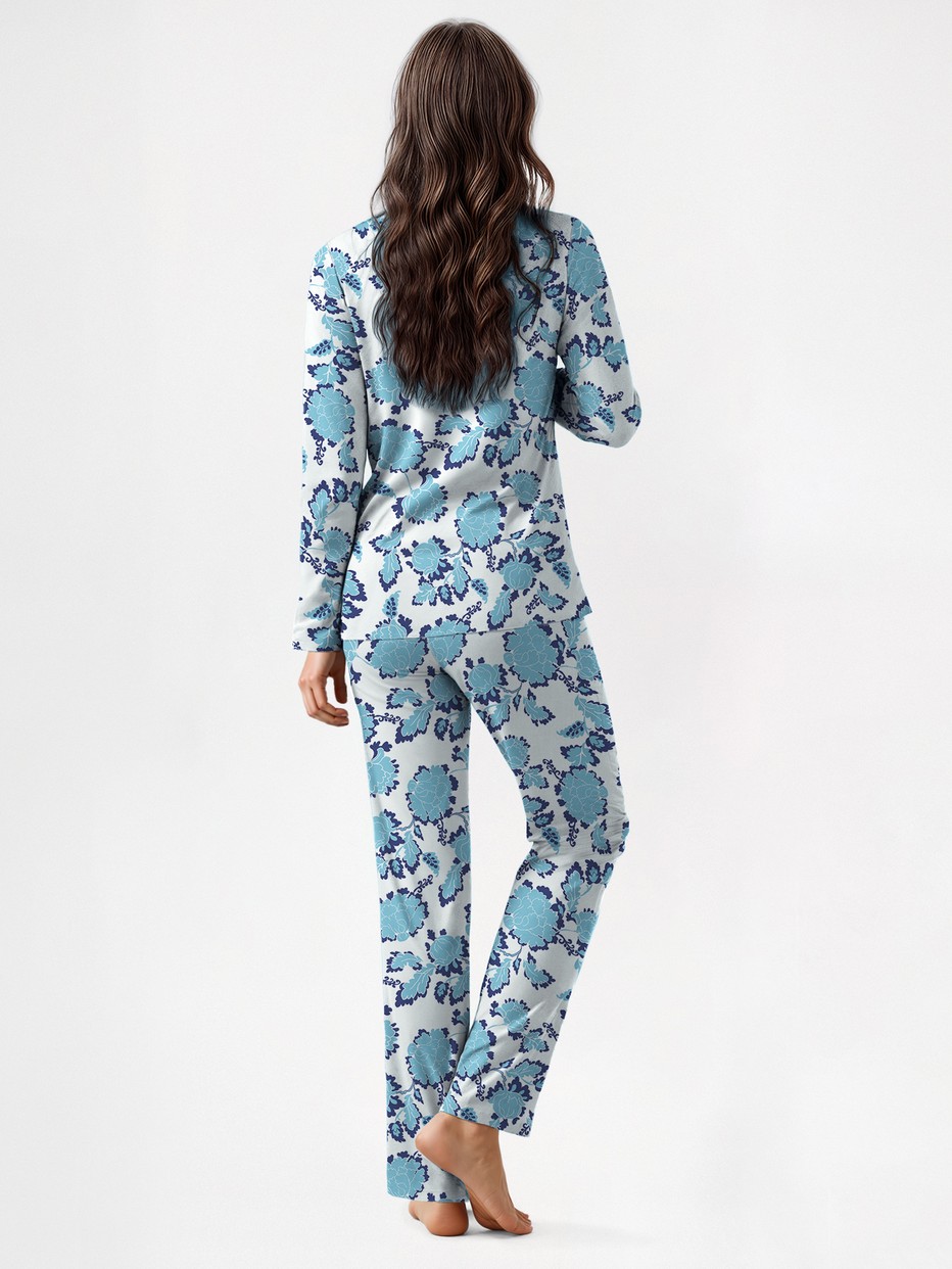 Women model is wearing Button-Up Pyjama made of 100% Cotton in Blue, Floral from the Nightwear Xtra series by CALIDA, Back view