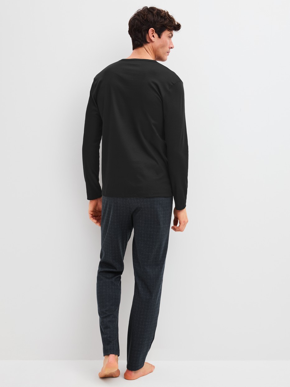 Men model is wearing Pyjamas, long made of 100% Cotton in Black, Patterned from the Relax Streamline 2 series by CALIDA, Back view