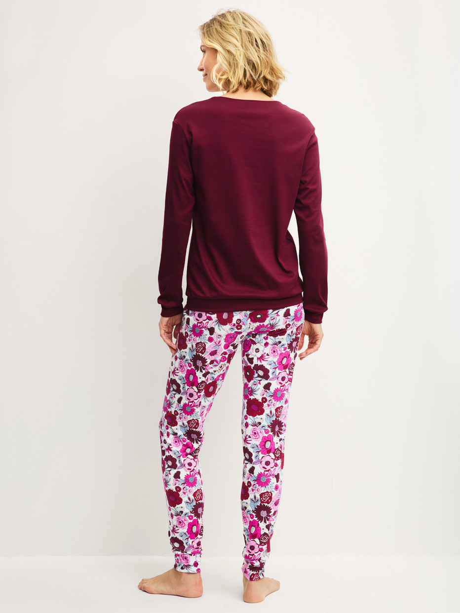 Women model is wearing Pyjama with cuff made of Swiss+Cotton in Red, Floral from the Season Special series by CALIDA, Back view