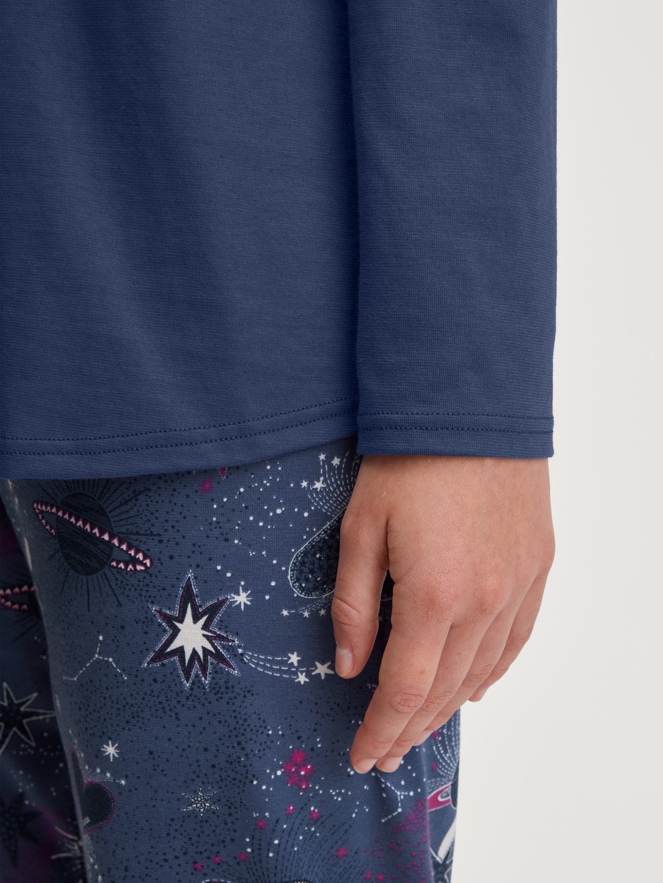 Women model is wearing Pyjamas, long made of 100% Cotton in Blue, Patterned from the Mystic Nights series by CALIDA, Detail