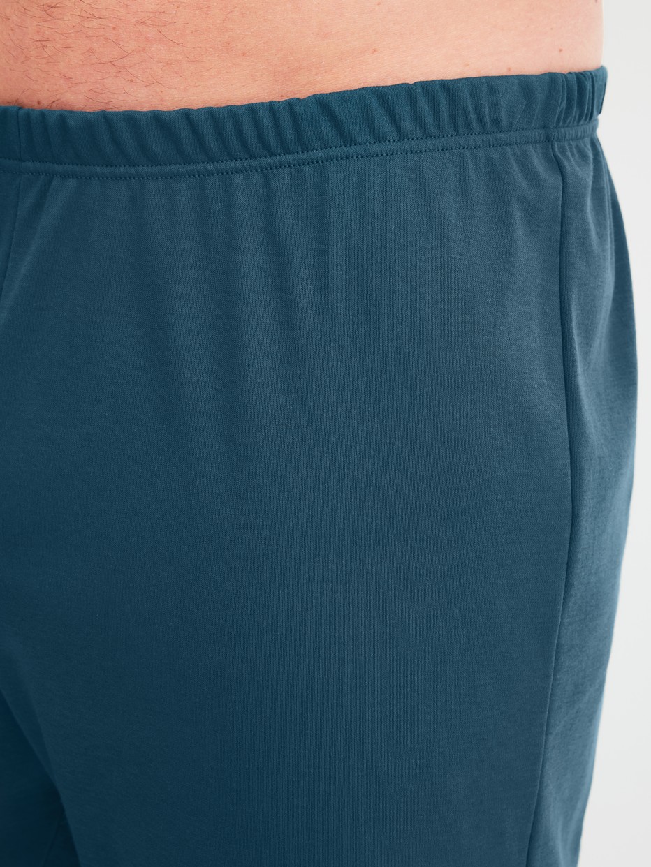 Herren-Model trägt Bündchen-Pyjama aus 100% Baumwolle in Türkis, Gemustert aus Serie Relax Streamline 1 von CALIDA, Detail