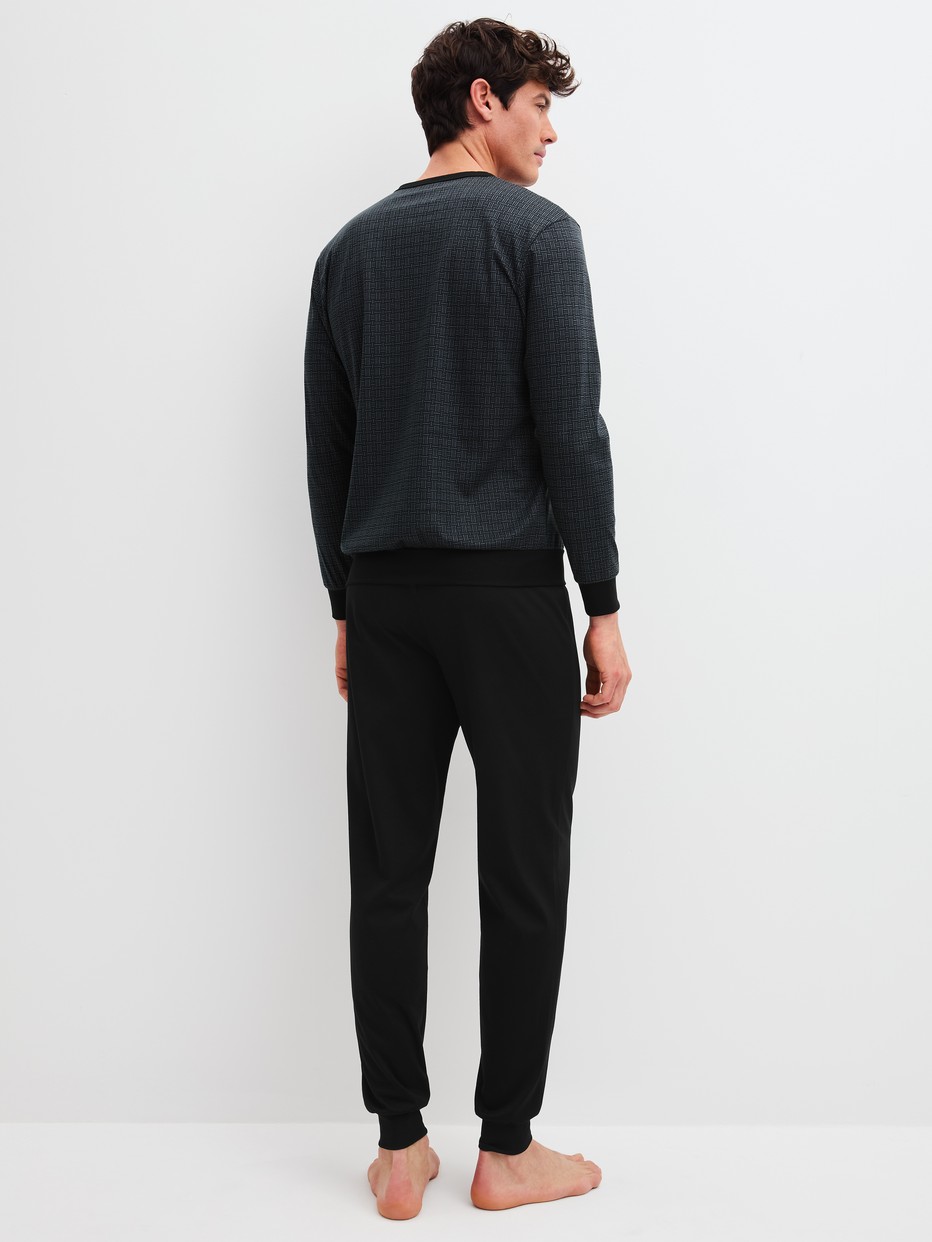 Men model is wearing Pyjama with cuff made of 100% Cotton in Black, Patterned from the Relax Streamline 2 series by CALIDA, Back view