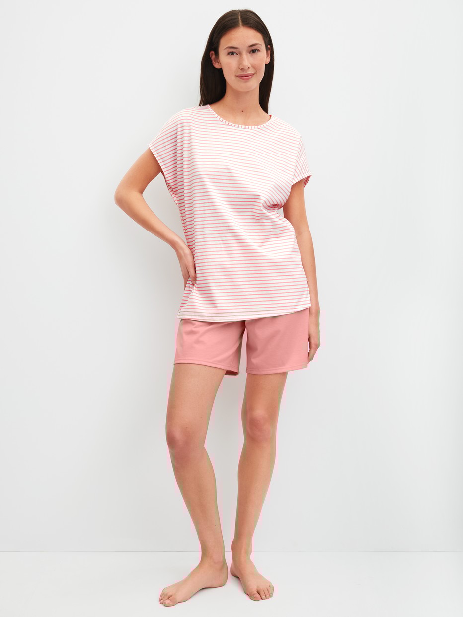 Women model is wearing Short Pyjama made of 100% Cotton in Orange, Patterned from the Lovely Nights series by CALIDA, Front view