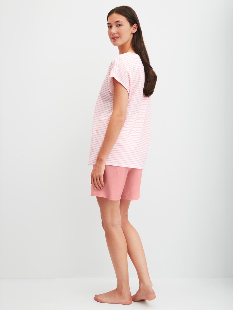 Women model is wearing Short Pyjama made of 100% Cotton in Orange, Patterned from the Lovely Nights series by CALIDA, Back view