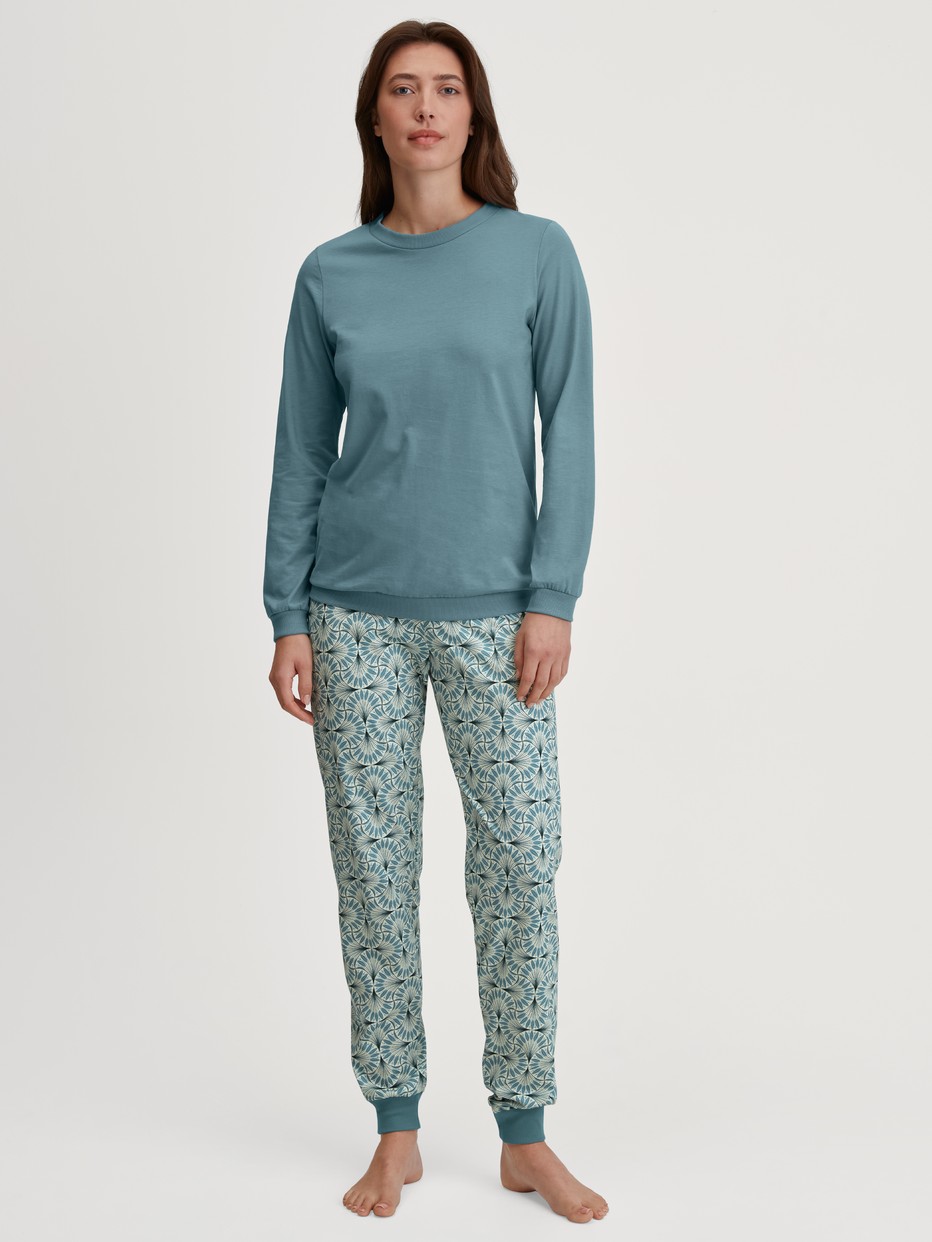 Women model is wearing Pyjama with cuff made of 100% Cotton in Blue, Patterned from the Ornament Nights series by CALIDA, Front view
