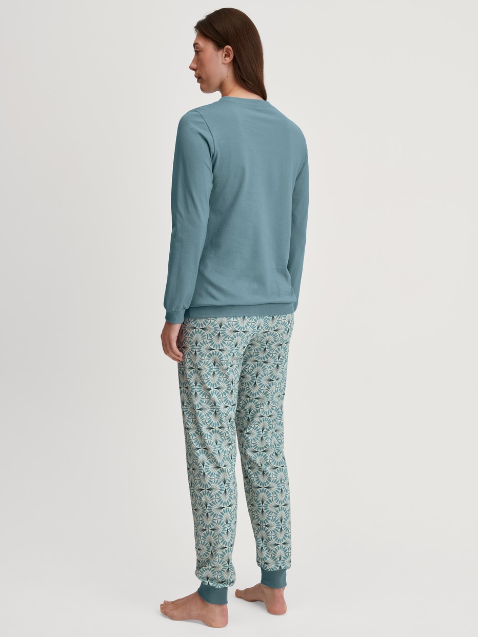 Women model is wearing Pyjama with cuff made of 100% Cotton in Blue, Patterned from the Ornament Nights series by CALIDA, Back view