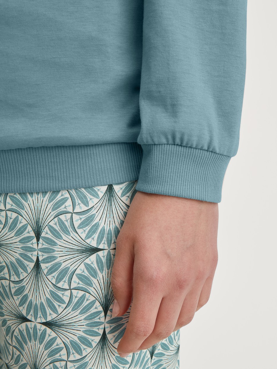 Women model is wearing Pyjama with cuff made of 100% Cotton in Blue, Patterned from the Ornament Nights series by CALIDA, Detail