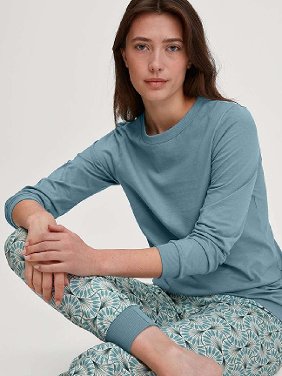 Damen-Model trägt Bündchen-Pyjama aus 100% Baumwolle in Blau, Gemustert aus Serie Ornament Nights von CALIDA, Vorderansicht