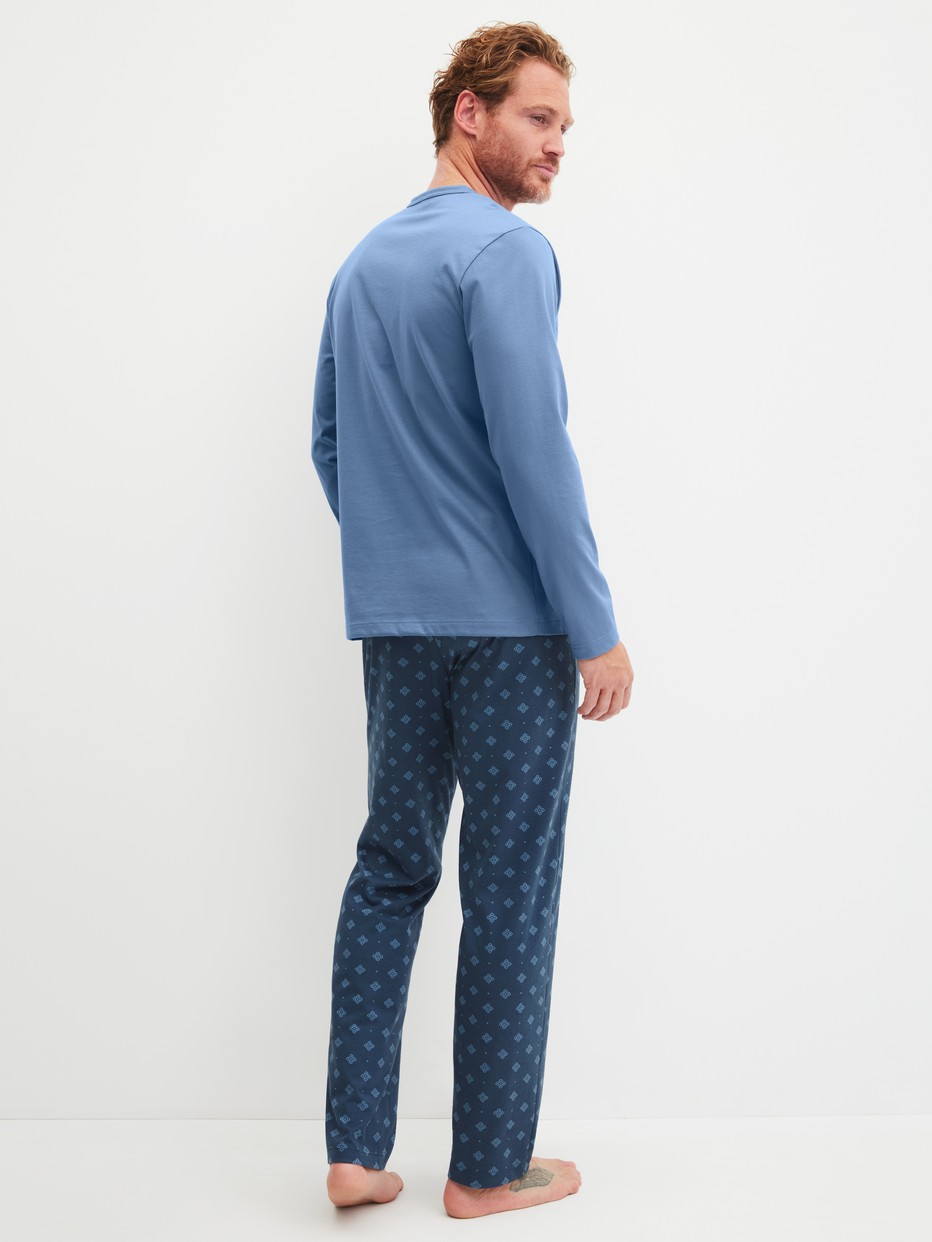 Men model is wearing Pyjamas, long made of 100% Cotton in Blue, Patterned from the Relax Imprint 2 series by CALIDA, Back view