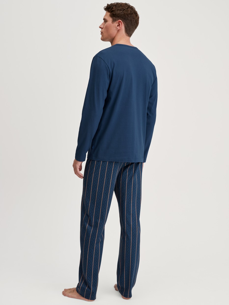 Men model is wearing Pyjamas, long made of 100% Cotton in Blue, Striped from the Relax Imprint 1 series by CALIDA, Back view