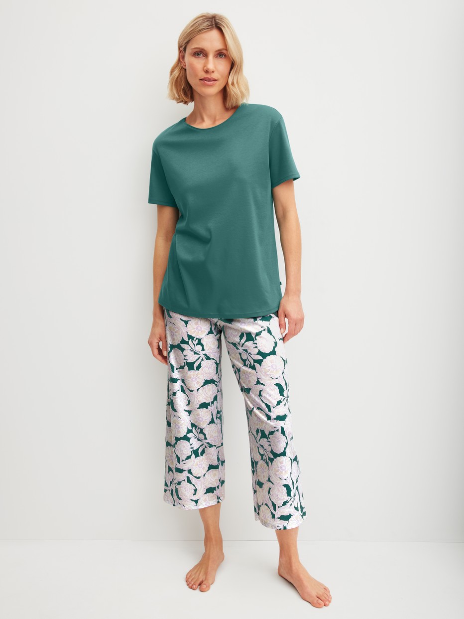 Women model is wearing 7/8 - Pyjamas made of 100% Cotton in Turquoise, Floral from the Botanic Dreams series by CALIDA, Front view