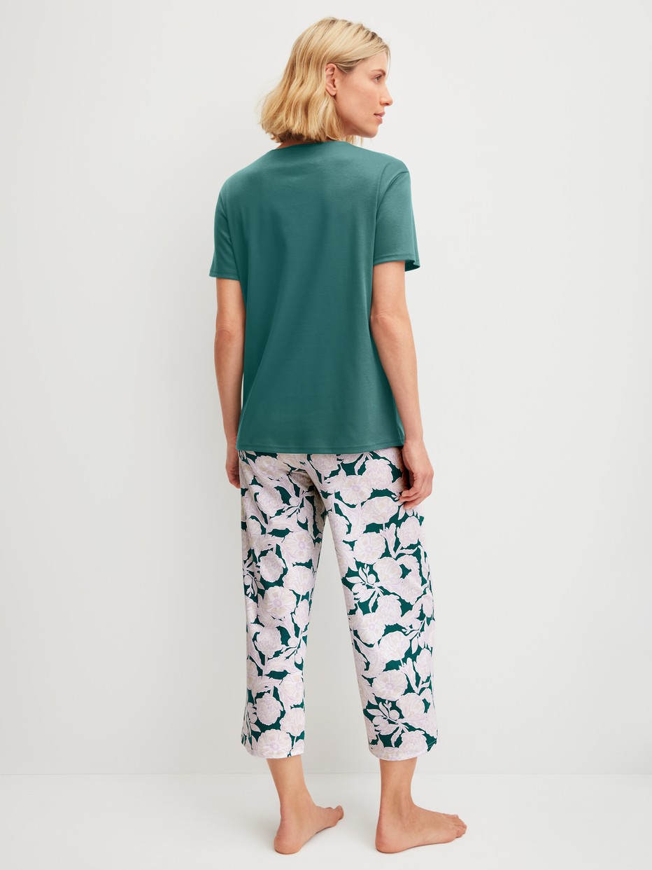 Women model is wearing 7/8 - Pyjamas made of 100% Cotton in Turquoise, Floral from the Botanic Dreams series by CALIDA, Back view